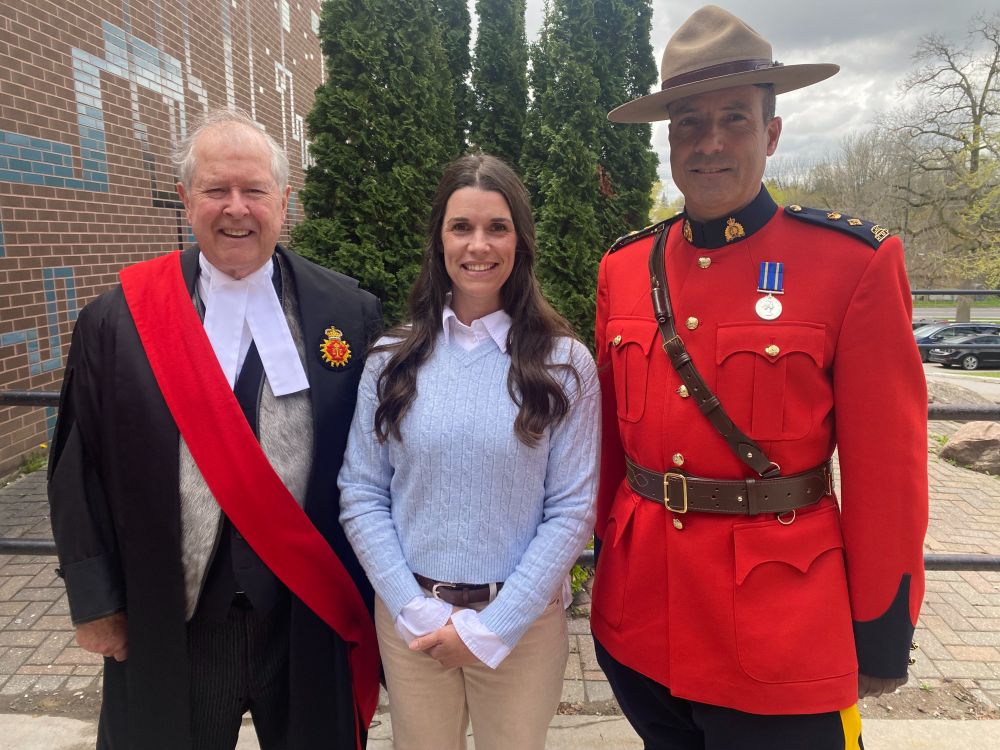 Emma stands between Retired Justice Alan Ingram and RCMP Inspector Tim Dell'Anna