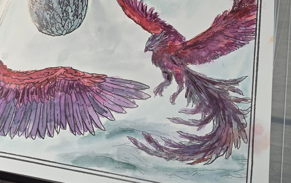Close up of flying phoenix and phoenix wing painted in reds and purples in the Dominant Industry Ink Archiving Book, A Log of Elixir.