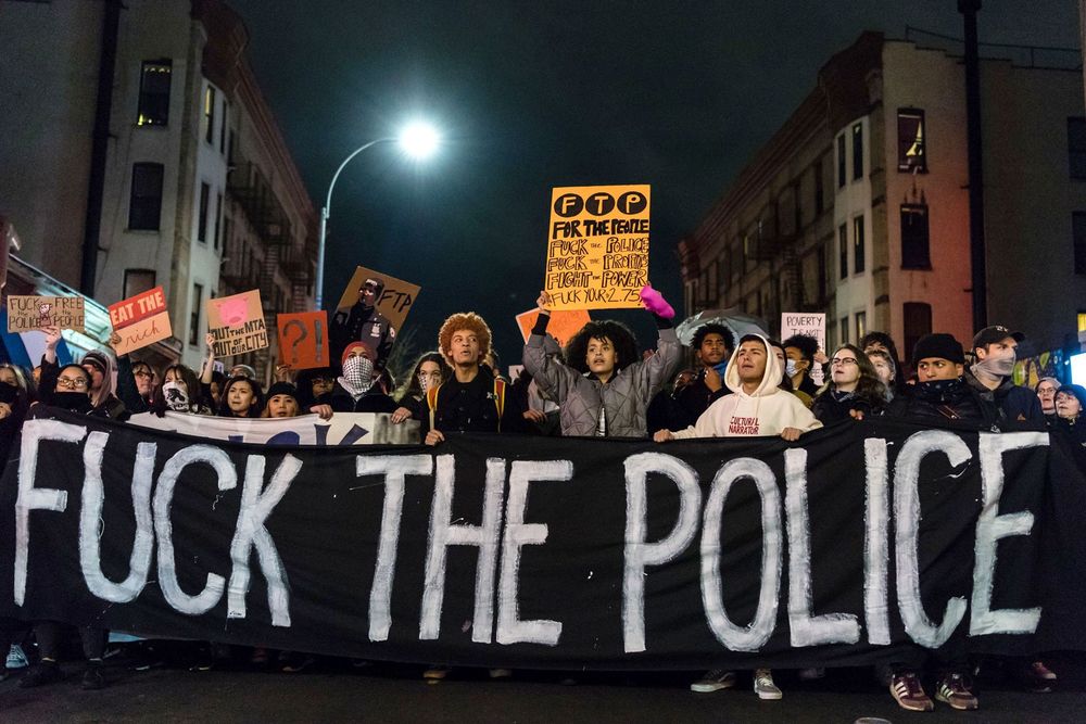 Photo from the BLM protests (in NYC I believe). A large number of protesters holding various signs, but the relevant thing is the giant black banner at the front that says, "FUCK THE POLICE"