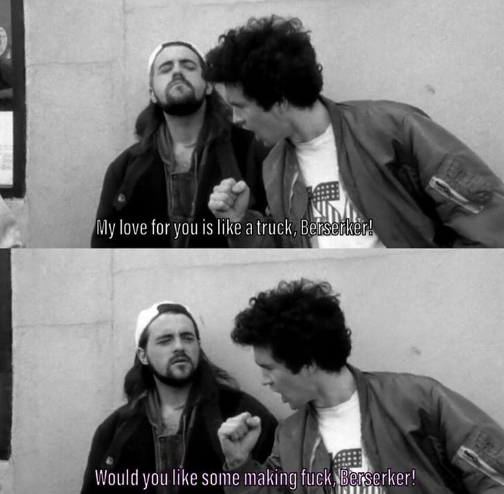 Screenshot from the 1994 movie Clerks. Silent Bob stands in front of the store while some Russian (?) guy wearing a USA shirt pretends to have a microphone in his hand and sings (poorly), 