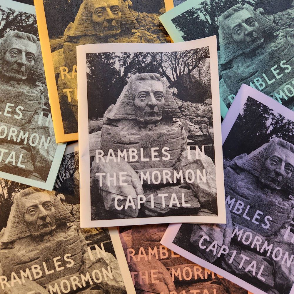 Multiple, different color copies of a zine titled "Rambles in the Mormon Capital" featuring a picture of a sphinx sculpted with the face of Joseph Smith. 
