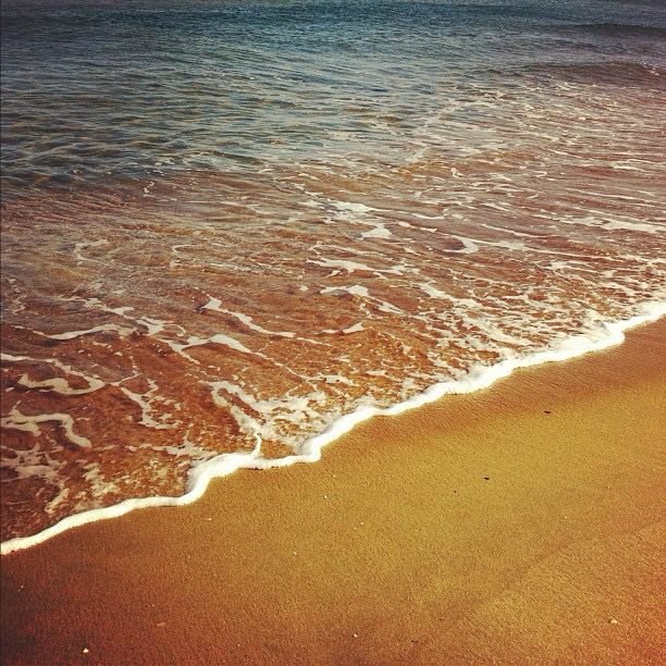 gentle waves washing over sand 