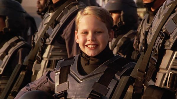 smiling blond child soldier from Starship Troopers in-movie late war enlistment advertisement.