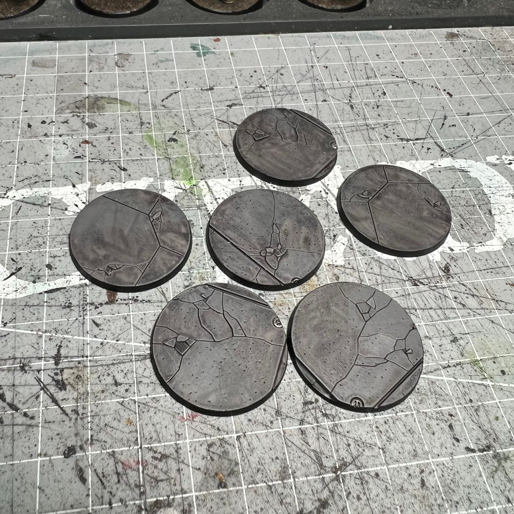 6 round bases painted to resemble concrete streets
