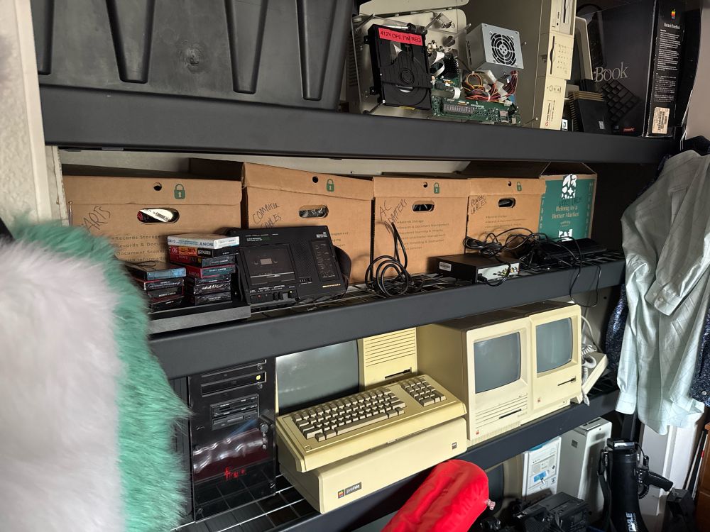 shelving in a closet full of vintage computers and other electronics 