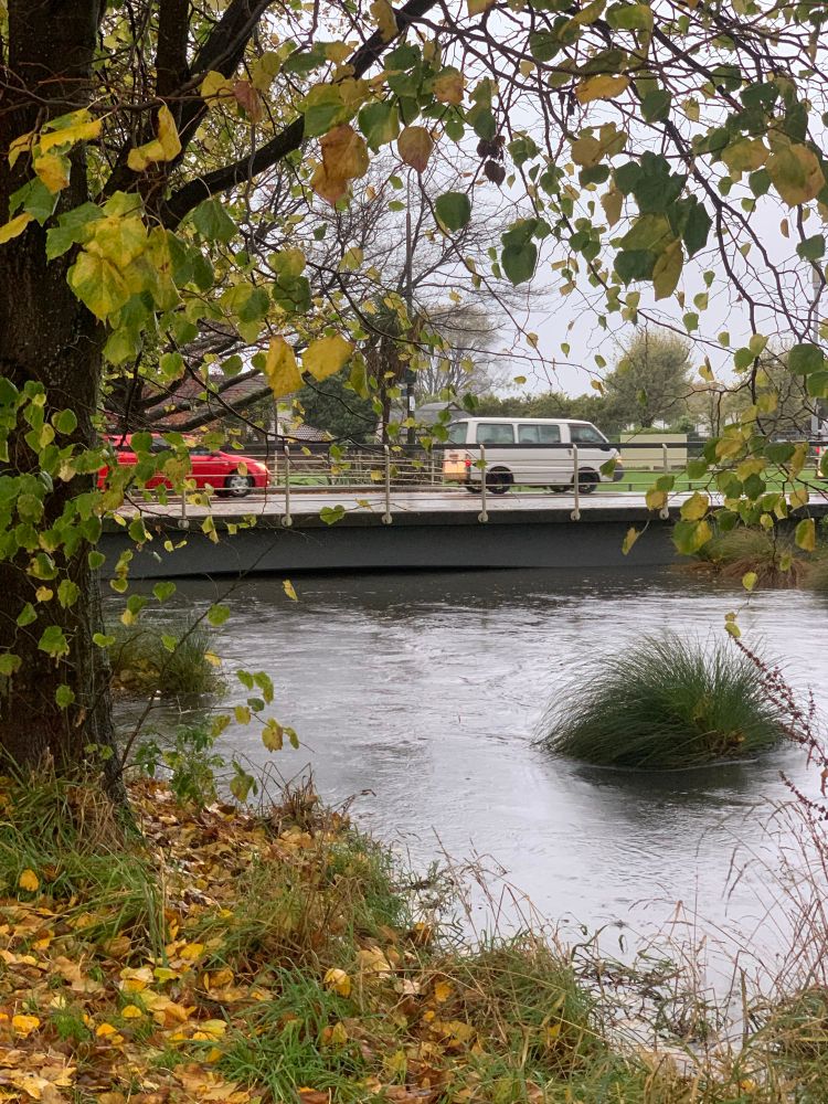 A picture of the Avon river swollen and almost reaching the top of the bridge at Barbadoes street