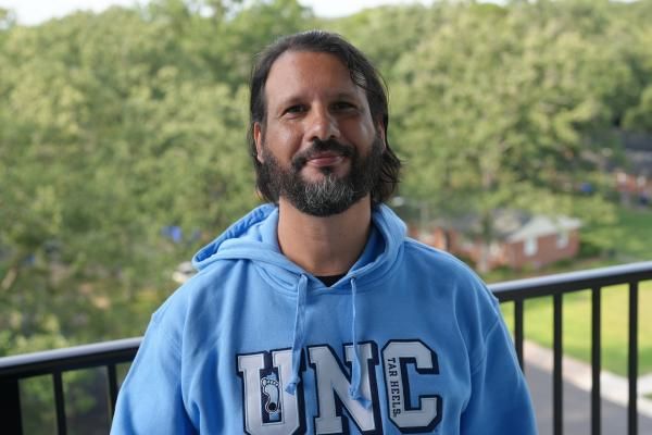 Lucelmo Lacerda wearing a University of North Carolina hoodie.