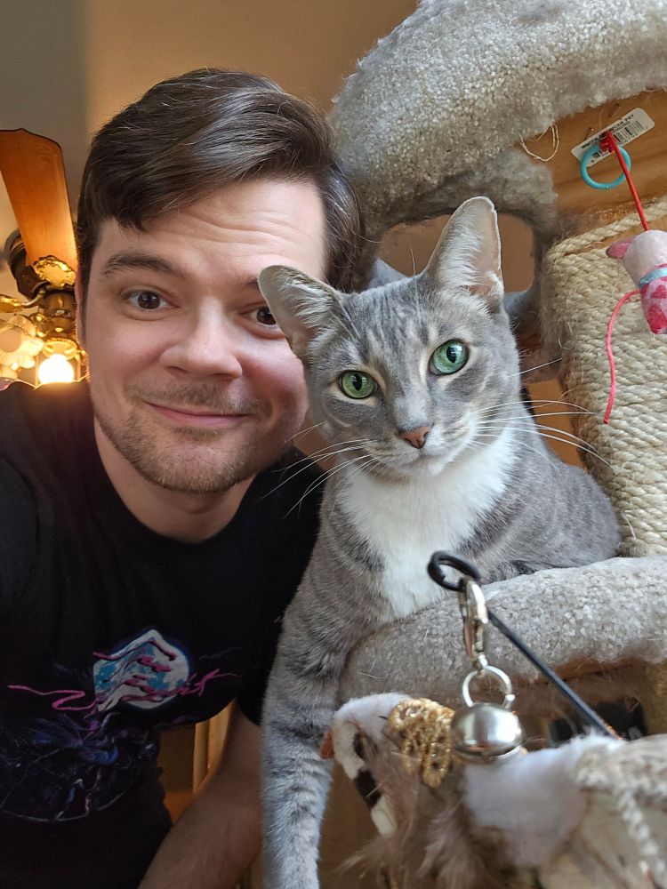 Rob and his cat smile at the camera