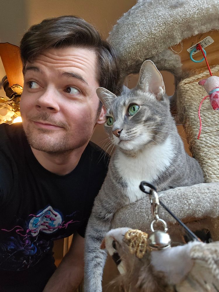Rob and his cat look off in the distance 