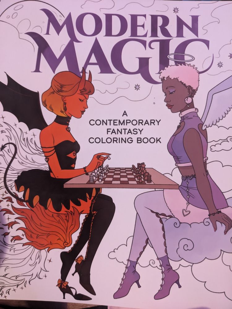 Front cover of "Modern Magic - a contemporary fantasy coloring book" with an angel and demon playing chess sitting on a cloud and fire respectively