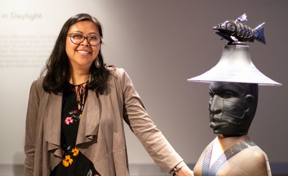 Miranda standing next to exhibit. 