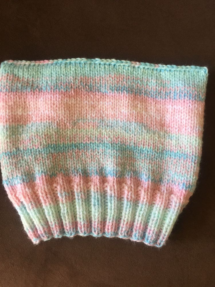 Pink, white, and blue striped hand-knit hat. 