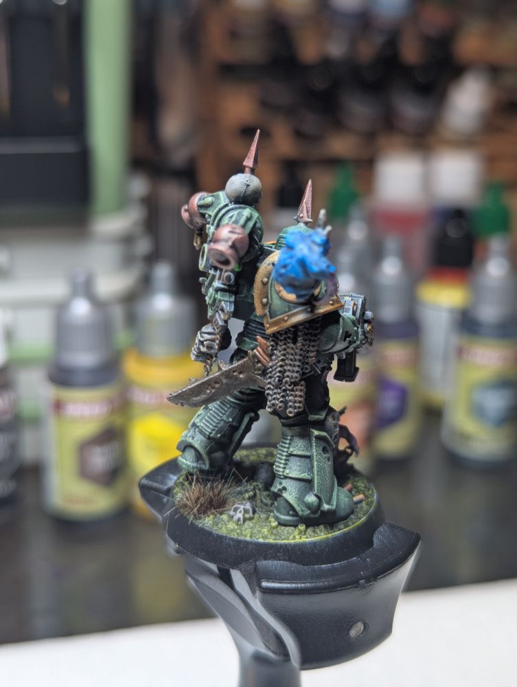 A Death Guard Plague Marine, clad in sticky green armor and accompanied by a couple nerglings