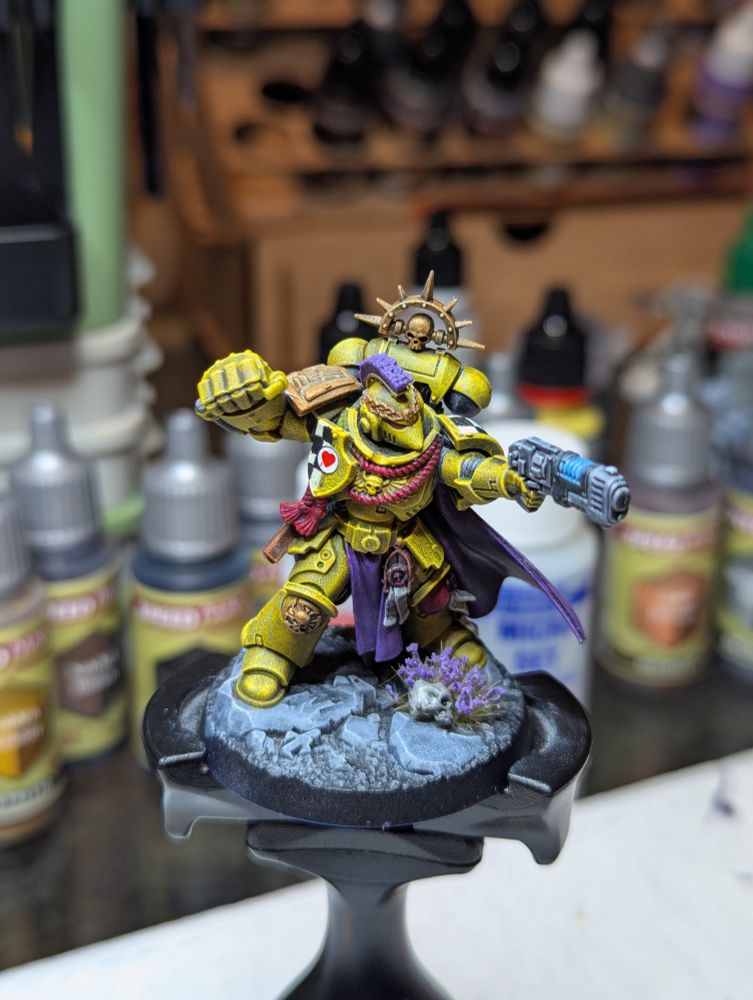 The Captain of the 3rd Company of the Lamenters, resplendent in his bright yellow armor and violet cape with bleeding heart iconography.