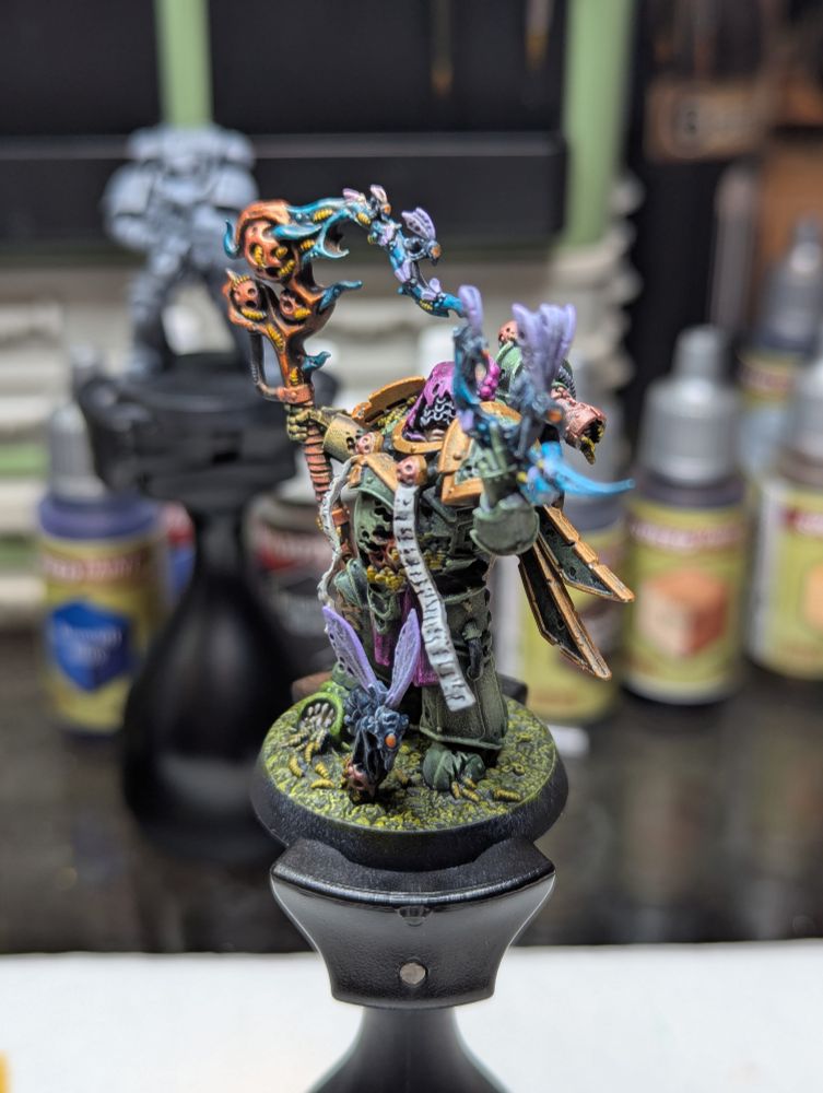 A Death Guard Plague Caster, in all his rotting, malignant glory. He summons forth a magical wave of pestilence while being constantly consumed by insects