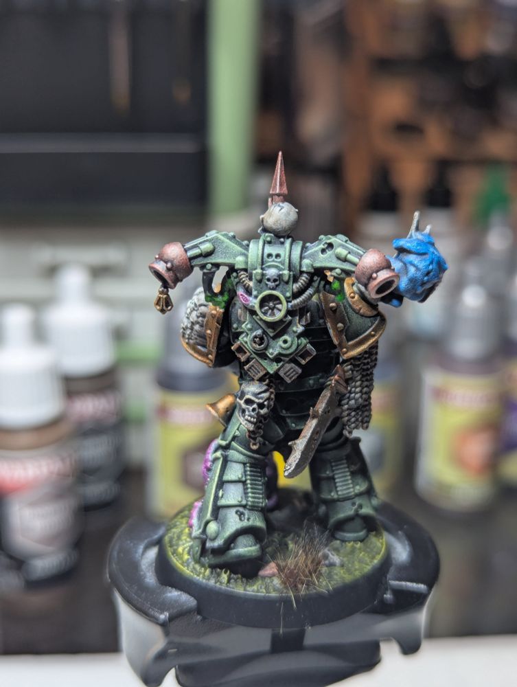 A Death Guard Plague Marine, clad in sticky green armor and accompanied by a couple nerglings