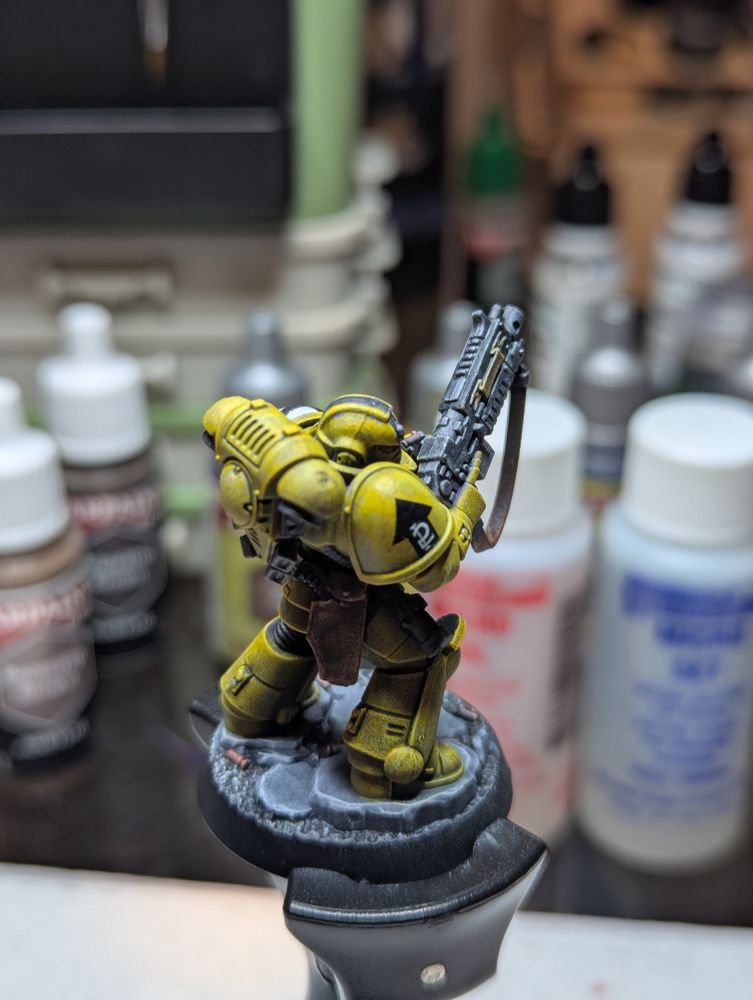 A Lamenters Sergeant, 2nd Squad, 3rd Company. He has a black stripe on his yellow helmet, indicating his status from the painting guides from many moons ago.
