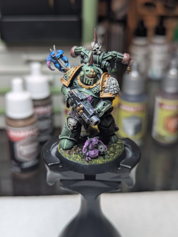 A Death Guard Plague Marine, clad in sticky green armor and accompanied by a couple nerglings. 