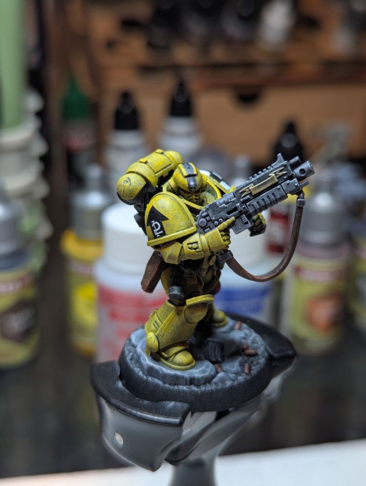 A Lamenters Sergeant, 2nd Squad, 3rd Company. He has a black stripe on his yellow helmet, indicating his status from the painting guides from many moons ago. 