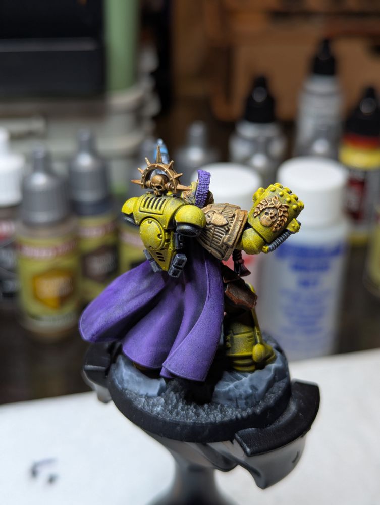 The Captain of the 3rd Company of the Lamenters, resplendent in his bright yellow armor and violet cape with bleeding heart iconography