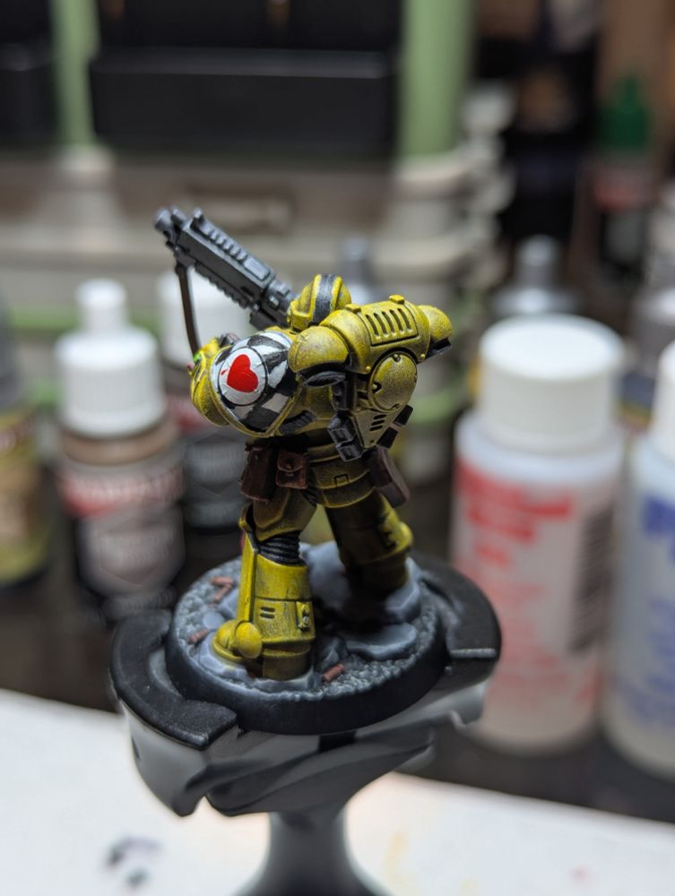 A Lamenters Sergeant, 2nd Squad, 3rd Company. He has a black stripe on his yellow helmet, indicating his status from the painting guides from many moons ago.