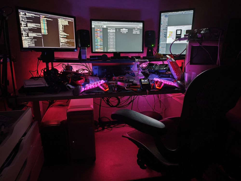 computer desk lit from behind in red and pink