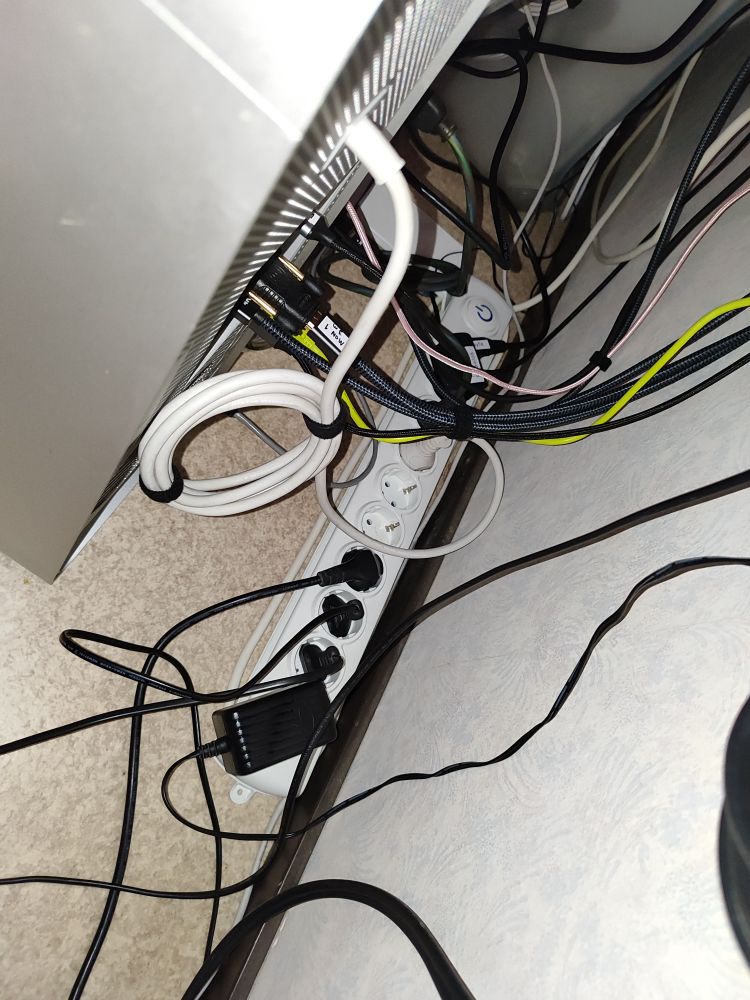power strip on the floor behind computers