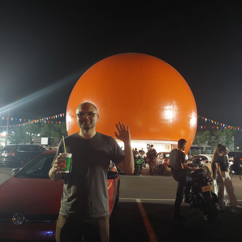 Me standing in front of a giant orange in Montreal.