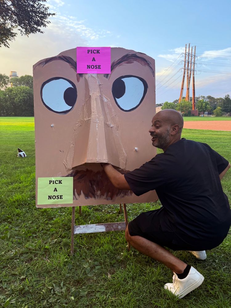 Minneapolis city Council President Elliott Payne sticking his hand up a sculpture’s nose 