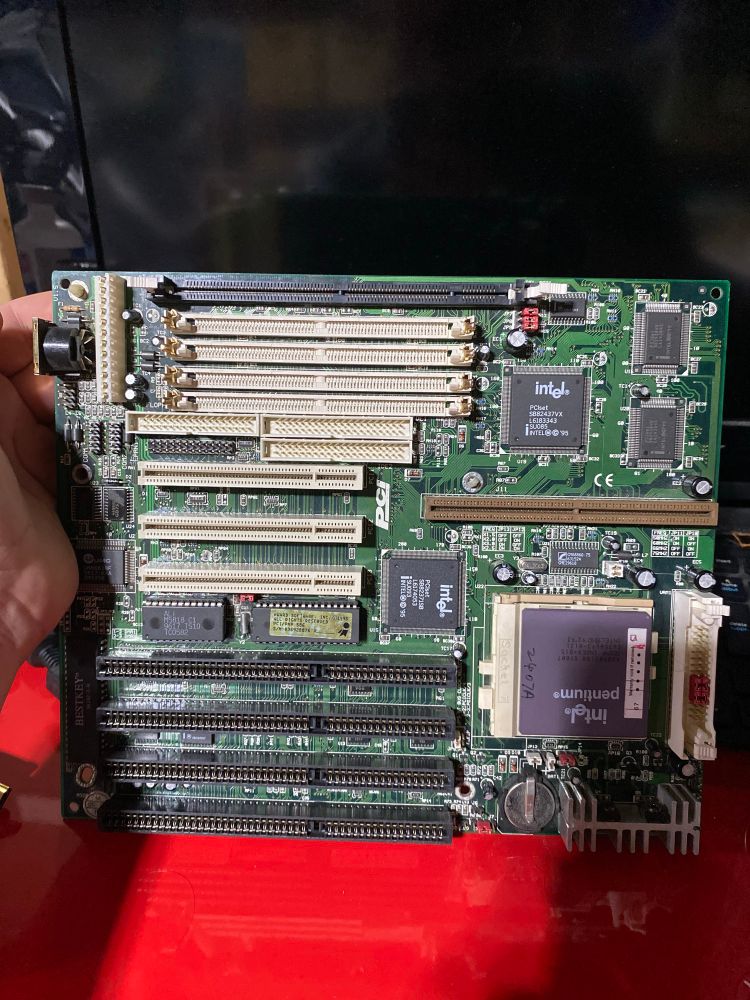 An old Socket 7 motherboard circa 1996. It has a Pentium CPU installed and a mixture of PCI and ISA slots