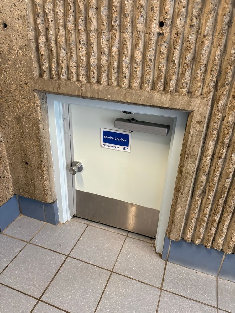 A door to a service corridor in a building no more than a few feet tall