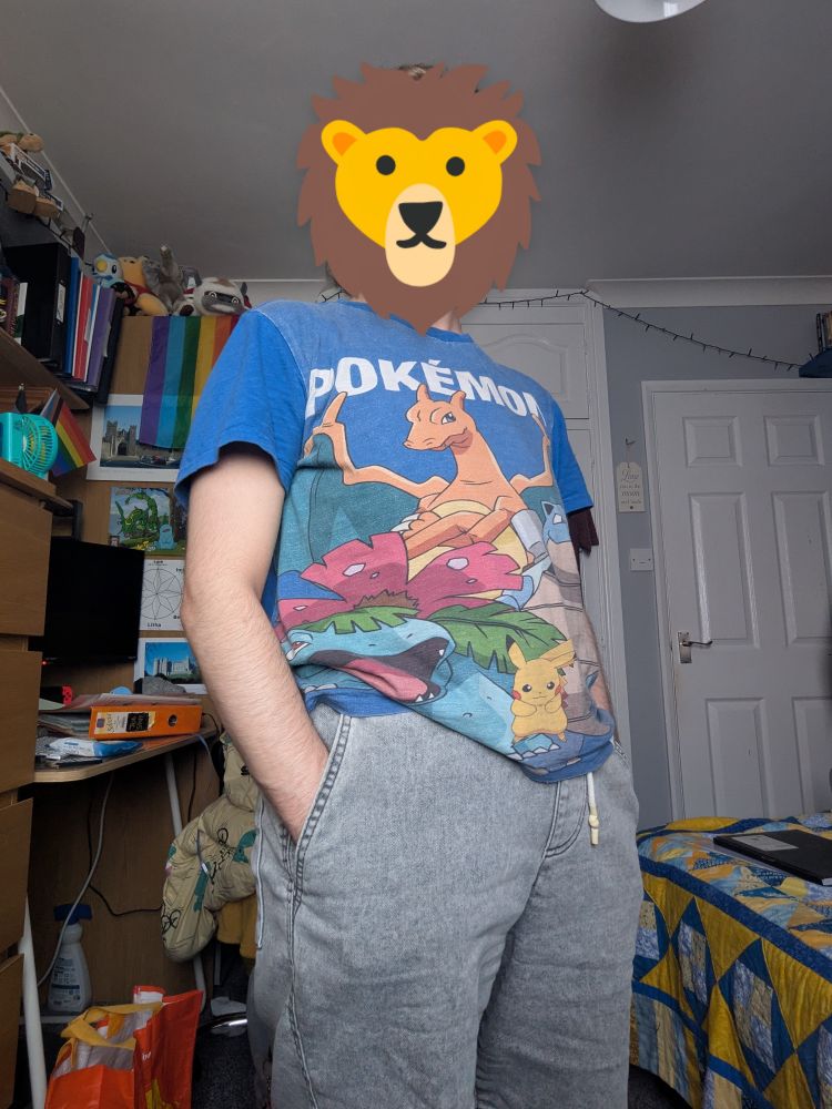 Person wearing a blue Pokémon t-shirt and grey shorts. 