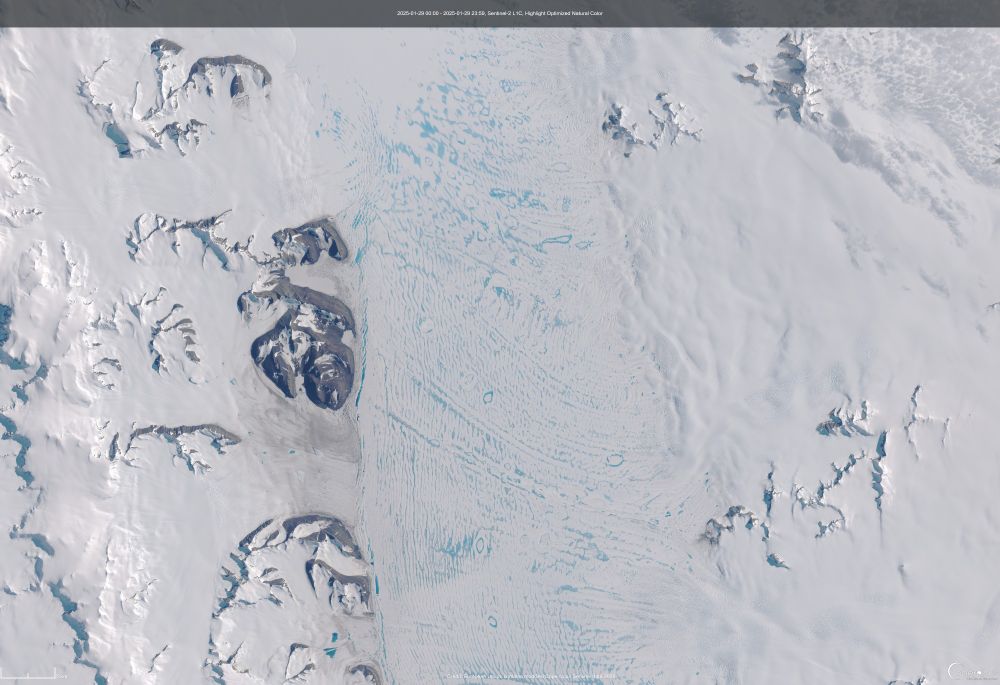 A satellite image showing lots of meltwater pool on an ice shelf in the centre, and rocky outcrops on the left (west) on Alexander Island, and Palmer Land on the right (east).