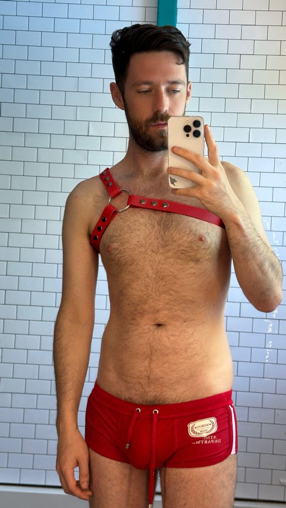 Me wearing some trunks I bought on a beach in Thailand and a red archer harness from @vegawork.shop
