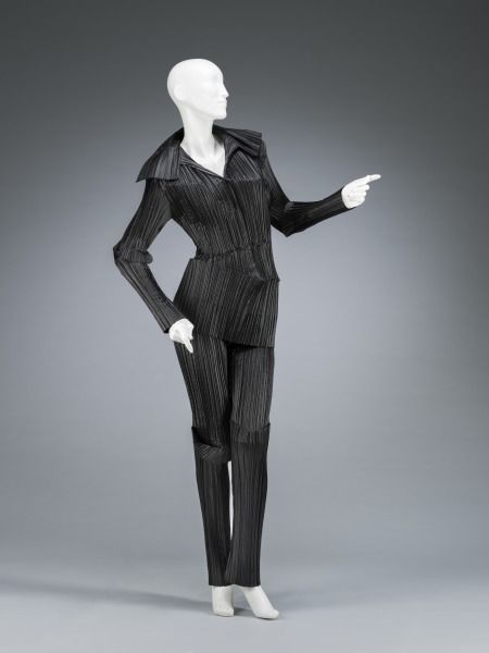 mannequin in a black pantsuit, pointing in two directions kinda like dancing