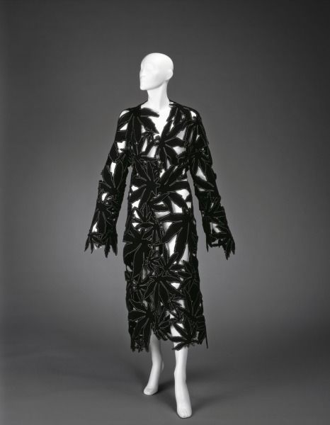 black and white coat and skirt with large marijuana leaves stamped out in the fabric