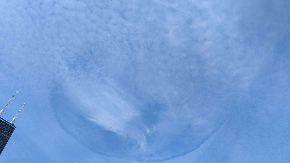 A opening within the thin clouds formed a circle above Chicago's Gold Coast, across from Oak Street Beach.
