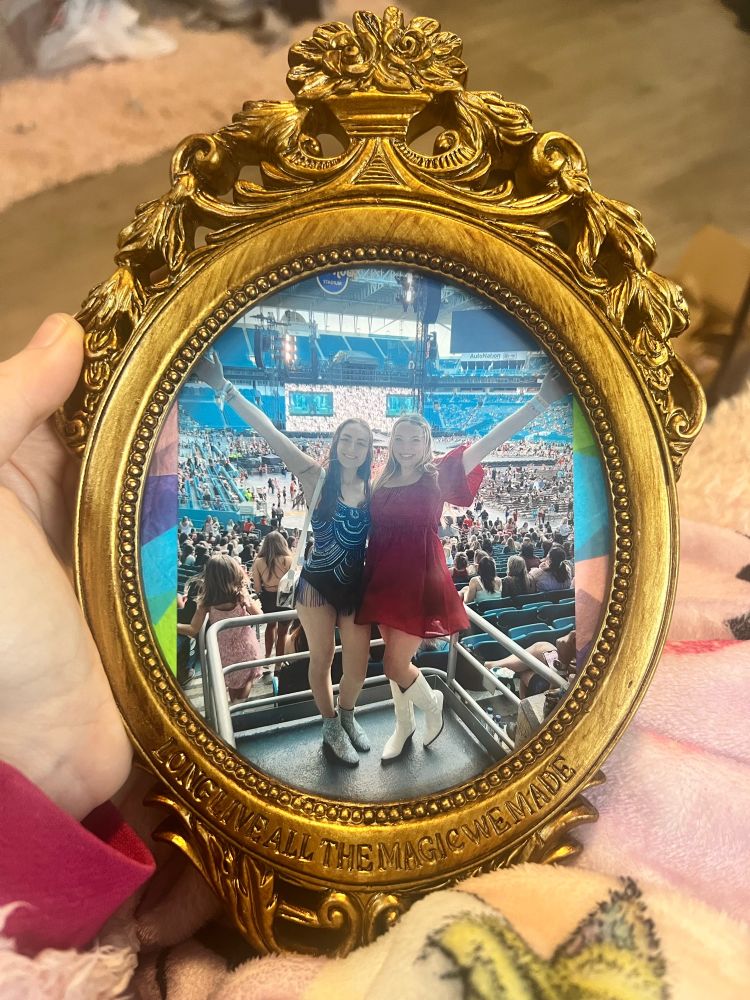 “Long live all the magic we made” picture frame from Taylor Swift’s website. It is a gold frame with a picture of a friend and I at the eras tour in Miami. It also has some confetti behind the photo.