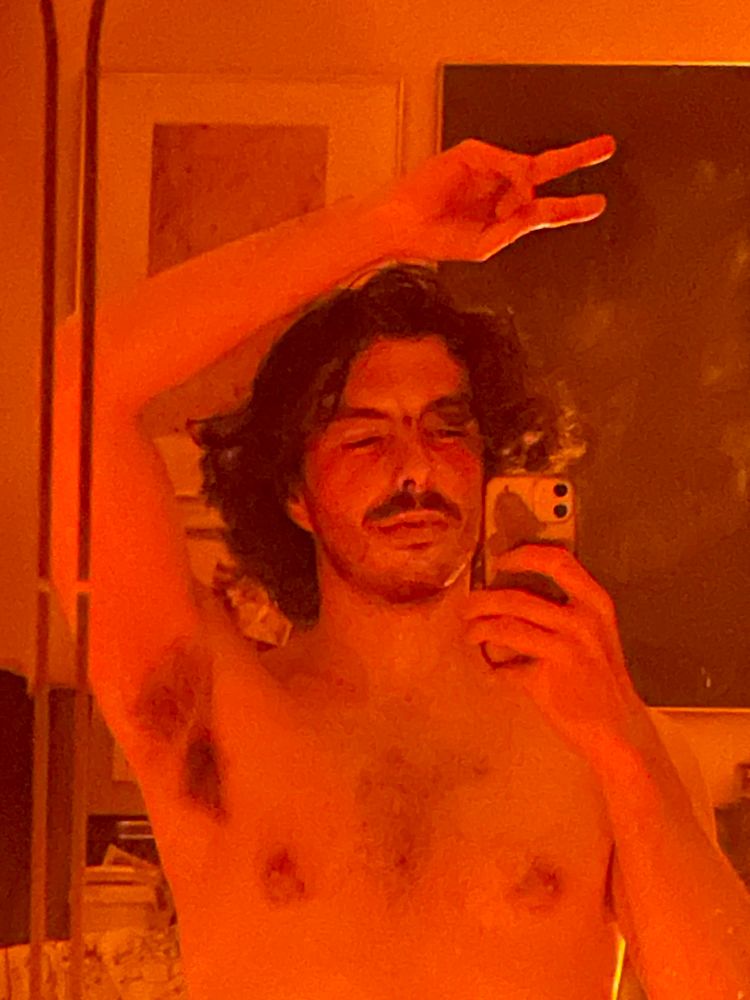 4 am me in the Mirror. And orange glow fills the room. Everything is tangerine. My left arm is above my head making a peace sign exposing my bushy armpit 