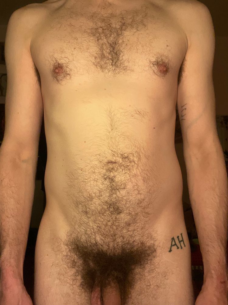My naked torso with my arms by my side. My busy soft cock pokes out at the bottom. 