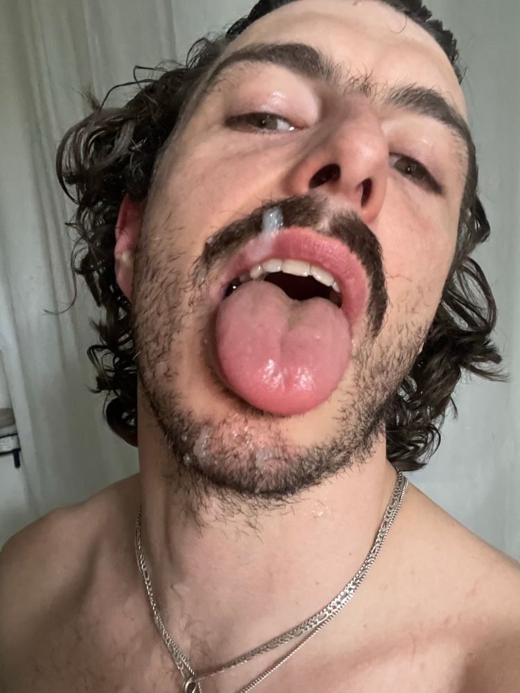 Man with mouth open and tongue out juicy cum load on moustache and chin 