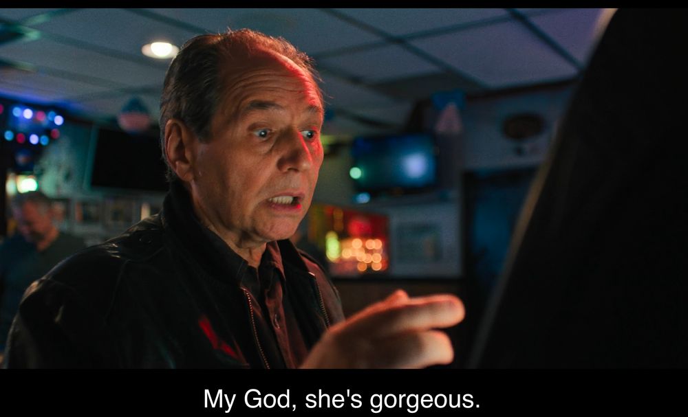 Mike from chair company stares at a bar video game babe