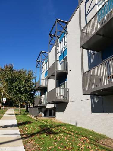 the side of an apartment complex, showing a ground floor cutout of the underground parking section that a pickup truck once tried (unsuccessfully) to enter