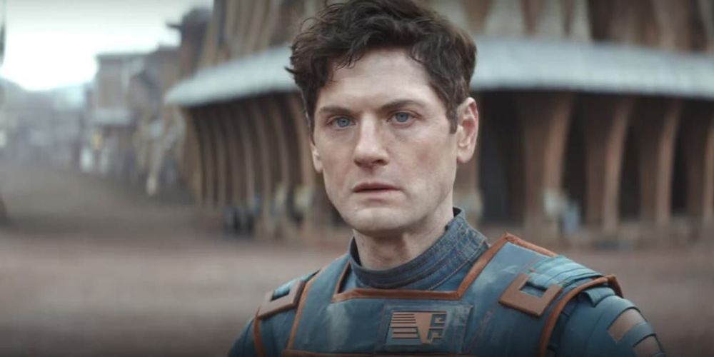 a brown haired blue eyed man looking forward