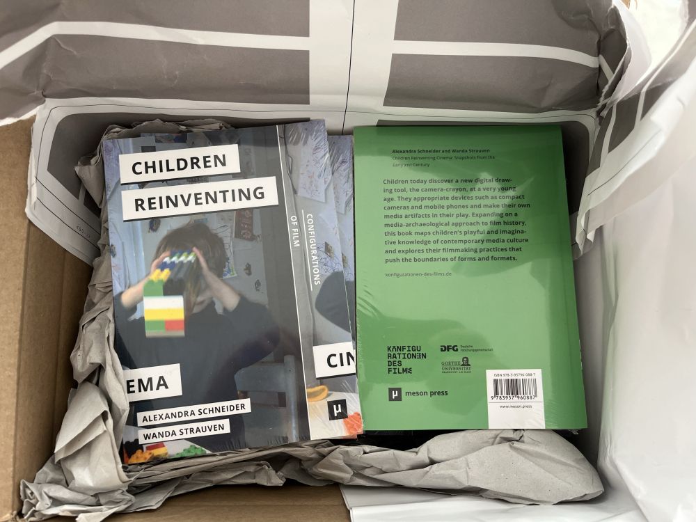 Printed copies of the book "Children Reinventing Cinema" by Alexandra Schneider and Wanda Strauven from the "Configurations of Film" series.