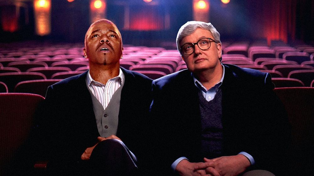 Sisqo, the guy who sang The Thong Song, with his head photoshopped onto Gene Siskel, sitting with Roger Ebert 