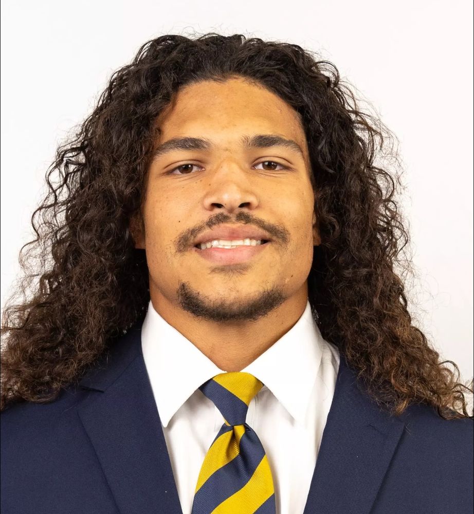 Teddye Buchanan's picture from when he played at Cal. His hair is slightly longer than shoulder length and very curly