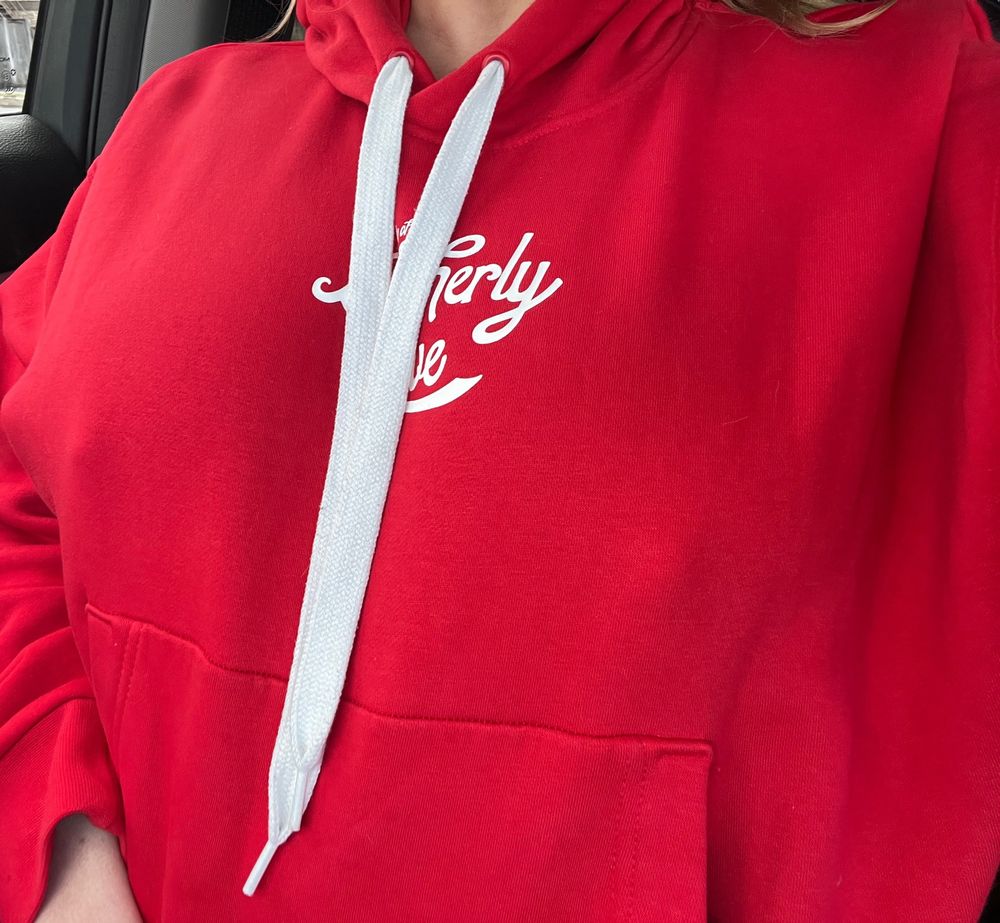 Fansly content creator wearing a thick red sweatshirt with thick hard nipples poking the fabric. 