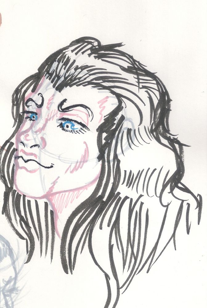 a longhaired man with blue eyes looks down towards stage left.