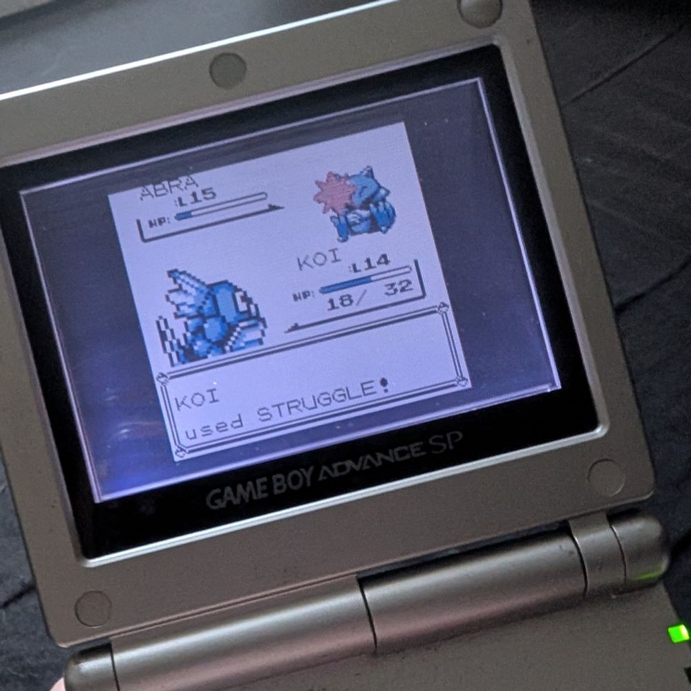 A photo of Game Boy Advance SP and Pokémon Blue
